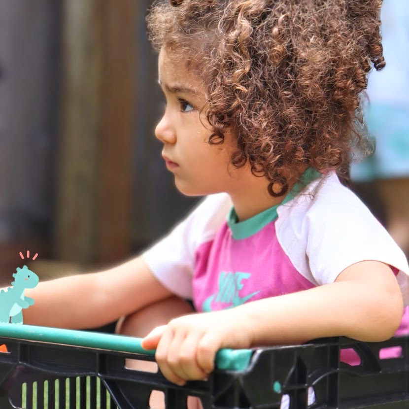 a great learner watching her friends play in the nursery's garden